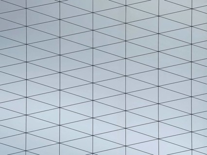 A gray surface featuring a modern geometric pattern composed of interconnected triangles. The