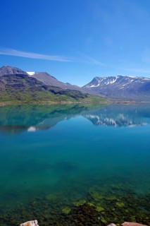 Clear lake with reflection of snow-capped mountains, peaceful atmosphere, Igaliku, North America,
