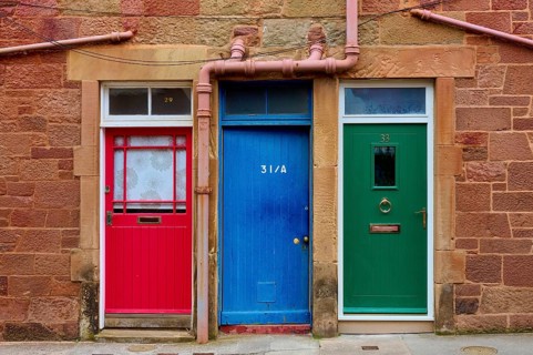A series of colorful doors in a building with red, blue and green paint, North Berwick, East