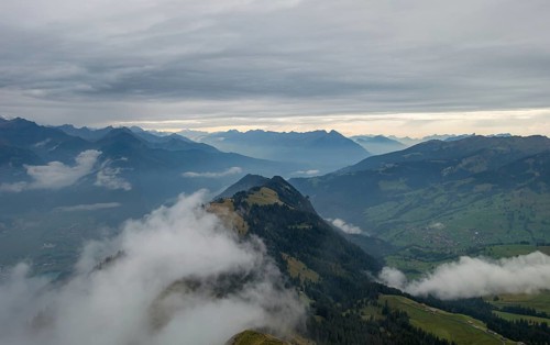 An early morning view of the mist-covered mountain peaks in the Bernese Alps, showcasing the serene