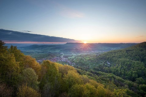 Mörikefelsen view over Zipfelbachtal valley and Drei Kaiserberge mountains at sunrise in spring.