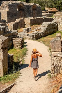 Woman walking in the archaeological ruins of Butrint or Butrinto National Park in Albania
