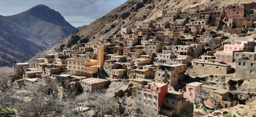 A densely built village on a mountain flank with terraced areas, Toubkal region, hiking in the High