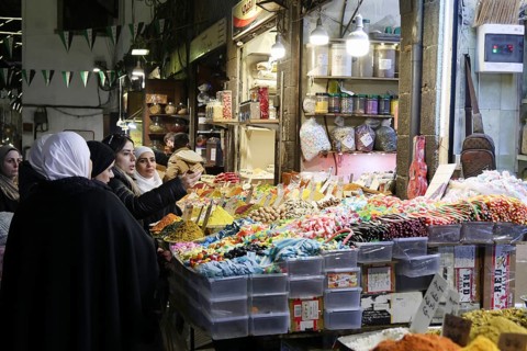 Syrians shop at the historic Al-Hamidiyah Bazaar adjacent to the Umayyad Mosque during the early
