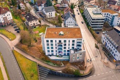 Residential complex at a crossroads with surrounding houses and small green spaces, Nagold, Calw