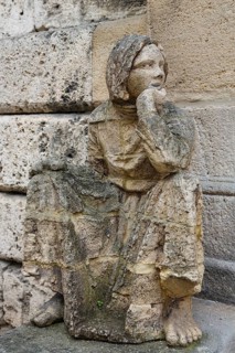Sculpture in front of the old school building, art in public space, stone figure, sculpture by the