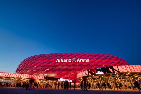 Visitors, fans, entrance area of the Allianz Arena, illuminated, overview, blue hour, in front of a