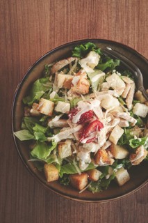 Classic Caesar salad, close-up, natural light, selective focus, horizontal