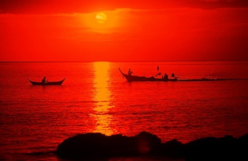 Fishing boats at sunset, silhouettes, orange filter, Ko Lanta island, Thailand, December 2002,