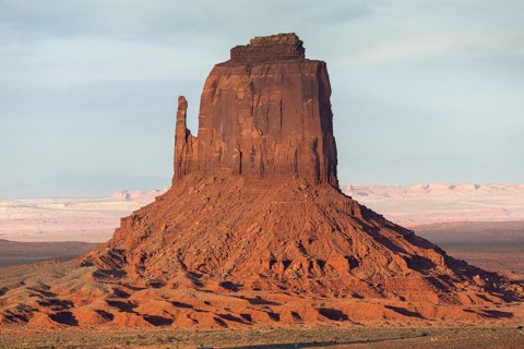 Captivating rock formation in Monument Valley, featuring striking red sandstone buttes under a