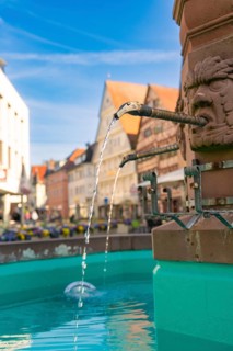 Close-up of a fountain in a town with flowing water and decorative details, Nagold, Black Forest,
