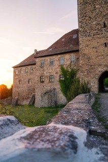 Front view of a historic castle with stone walls at sunset, Allstedt, Harz, Germany