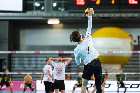 Volleyball player serves ball during the match