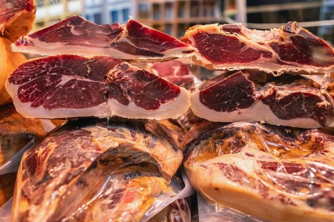 Various pieces of high-quality Spanish jamón, Ibérico, Serrano, ham in the Markthalle Stuttgart,