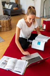 Young student learns at home, online, on her notebook