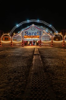 Circus entrance at night with illuminated tent structure and arches, Böblingen, Germany