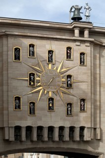Large golden wall clock with twelve figures at the back of the Dynasty Palace, Brussels, Belgium