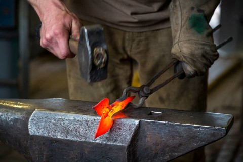 A blacksmith forging, working at the Ehnert forge in Dresden-Bühlau, Saxony, Germany