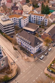 Urban intersection with a clear view of surrounding buildings in the evening, VHS Oberes Nagoldtal,