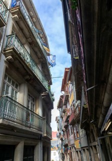 Historic buildings narrow street houses with balconies, Ribeira district, city of Porto, Portugal