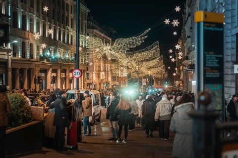 Christmas street view with angels and people walking by, New Year's Eve London, Great Britain