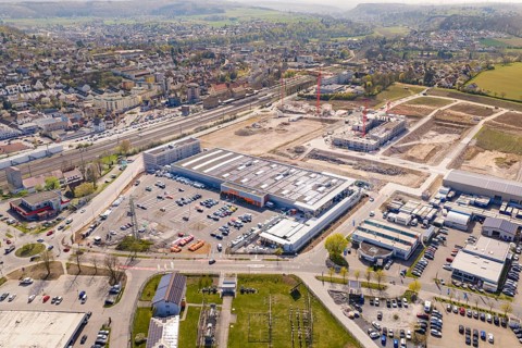 Urban industrial site with construction work and solar panels on large buildings, PV plant at Obi