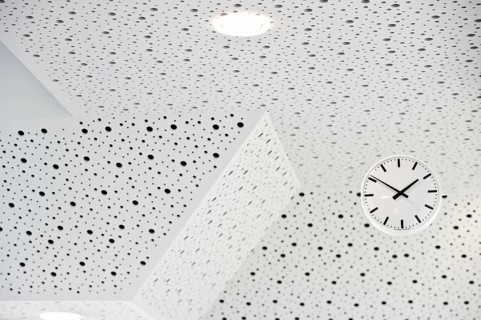 Black and white clock on a black and white ceiling, symbol of time
