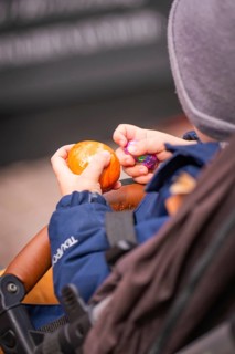 A child holds colorful eggs in a stroller and examines them, Easter campaign, Sindelfingen,