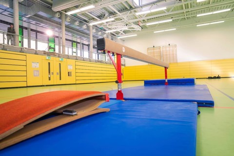 Sports hall with balance beams and damping mats, yellow and blue dominate, gymnastics, Calw,