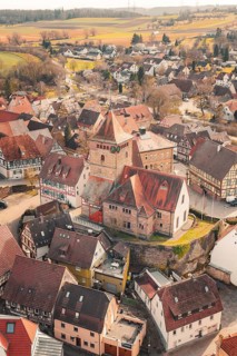 View of a village with a church surrounded by half-timbered houses in a hilly landscape, Ötisheim,
