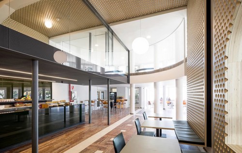 Bright and spacious modern bar interior with natural light, wooden accents, and contemporary