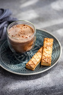 Enjoy a delicious puff pastry filled with sweet apricot jam, served with a freshly brewed cup of