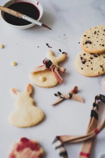 Top view of homemade Easter bunny cookies creatively painted with hibiscus tea, paired with a