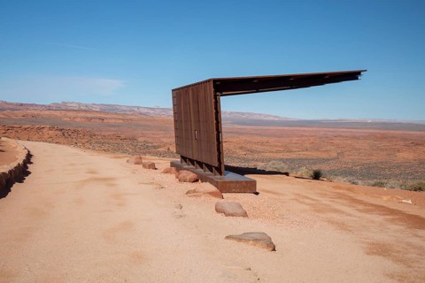 Page, Arizona - A shade structure offers tourists relief from the desert sun along a trail leading