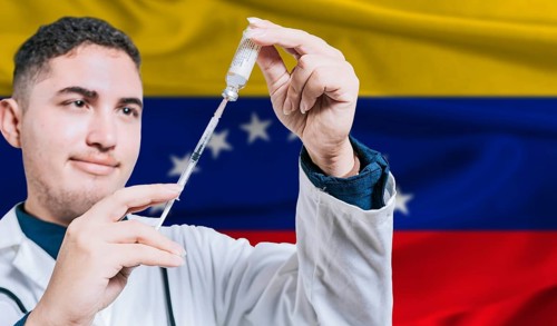 Doctor holding syringe on Venezuela flag background. Medical professional holding syringe with