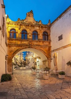 Illuminated Arco Scoppa archway at night, Ostuni, Apulia, Puglia, Italy