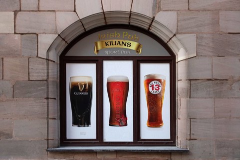 Advertisement on a window of an Irish pub, Nuremberg, Middle Franconia, Bavaria, Germany