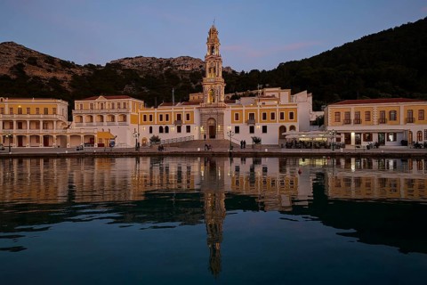 Night view of an illuminated church with reflection in the calm coastal waters, Holy Week, Bay of