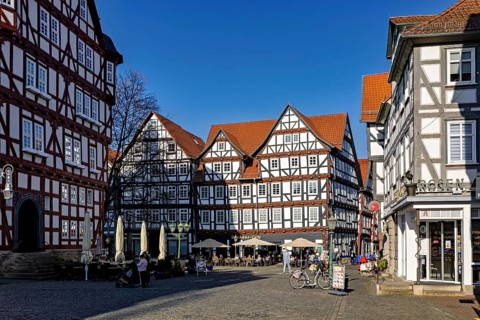 Historic market square with impressive half-timbered houses under a blue sky, The old town centre