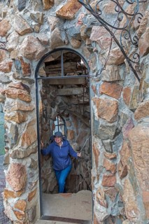 Rye, Colorado, A visitor climbs an interior stairway at Bishop Castle. The Castle is an elaborate