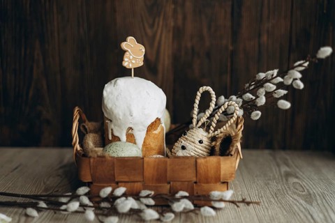 An ornate setup displaying traditional Russian Easter bread, Kulich, garnished with a gingerbread
