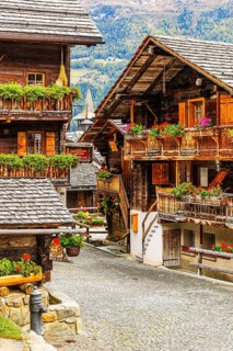 Old wooden houses decorated with flowers in the historic village centre, Grimentz, Val d'Anniviers,