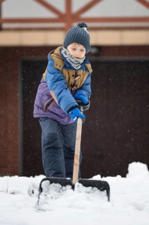 Little boy ploughs the drive