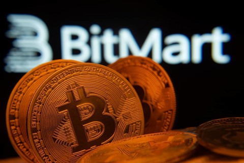 Dhaka, Bangladesh- 03 Sep 2025: Close-up of Bitcoin coins with the Bitmart logo visible on a screen