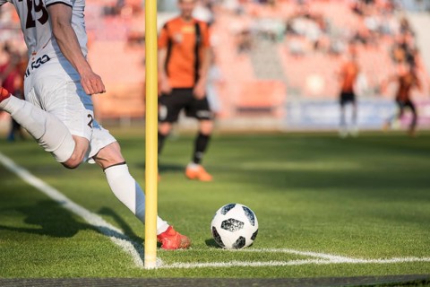 Player takes the corner during professional football match.
