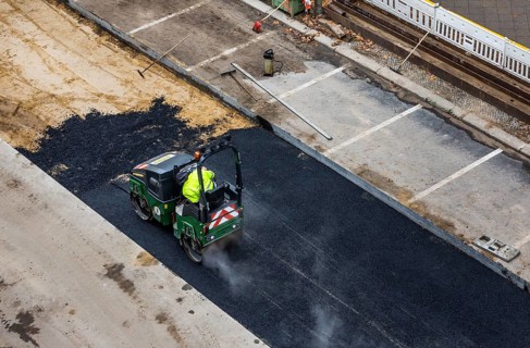 Tandem roller compacts an asphalt surface following road repair, Schöneberg, Berlin, Germany