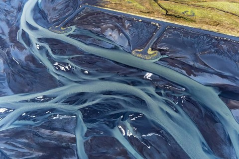 Captivating aerial view showcasing the intricate natural patterns of rivers winding through the