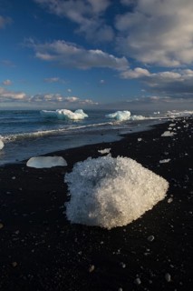 Little icebergs and crushed ice on the black beach at Joekulsarlon glacial lake