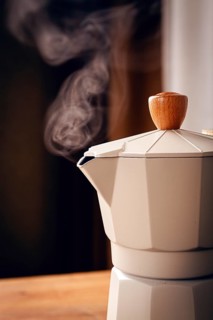 Geyser coffee maker, beige, close-up, boiling, steam from the spout, morning, breakfast, no people