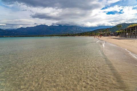The beach and mountains at Calvi Bay, Balagne, Corsica, France